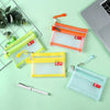 A collection of transparent zipper pouches in yellow, orange, and light blue for coins and cards.