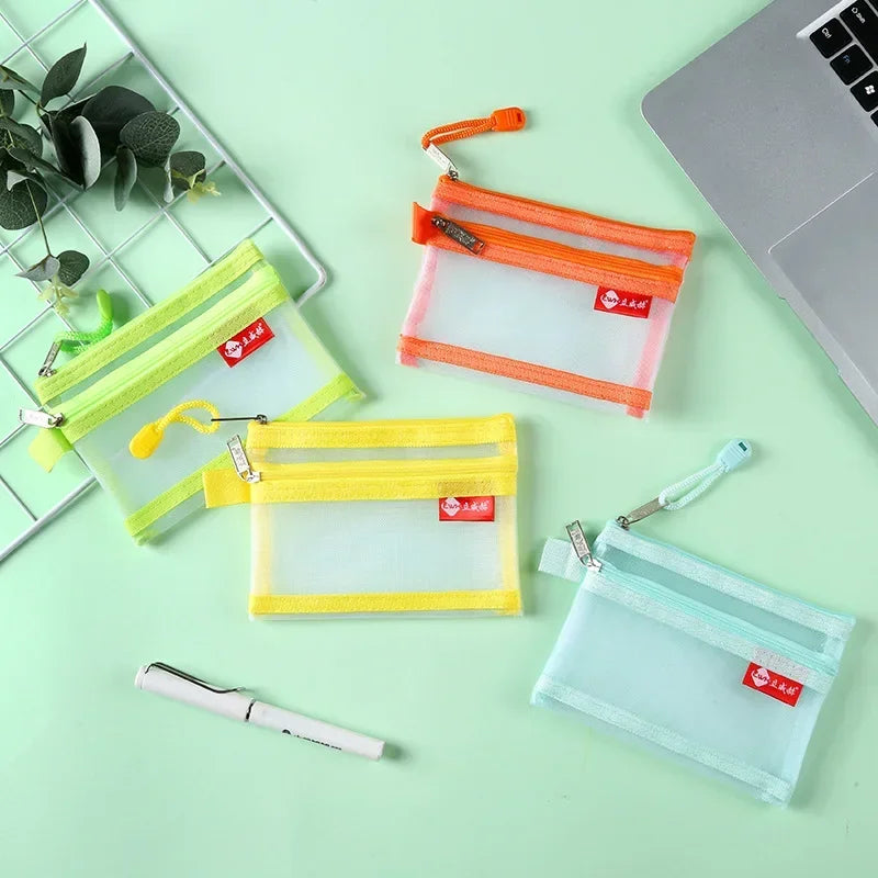A collection of transparent zipper pouches in yellow, orange, and light blue for coins and cards.