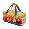 A colorful quilted travel duffle bag featuring peace signs and floral patterns.