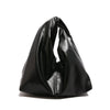 A black leather minimalist crossbody tote bag folded and displayed against a white background.