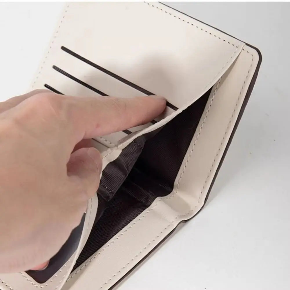 A hand is opening a beige fashion PU leather slim card holder wallet, showing the interior.