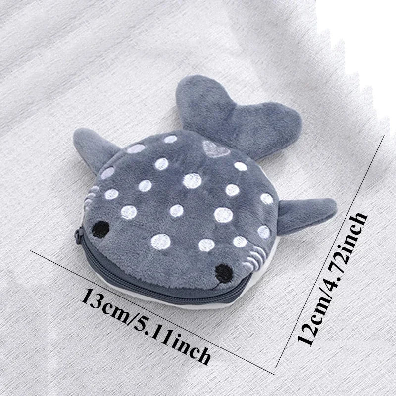 A gray shark mini plush coin purse wallet with white polka dots shown against a light fabric background.