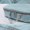 A light blue mesh travel organizer bag with gray straps and zipper, shown in multiple views.