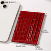 A red crocodile pattern slim card holder wallet next to a white smartphone.
