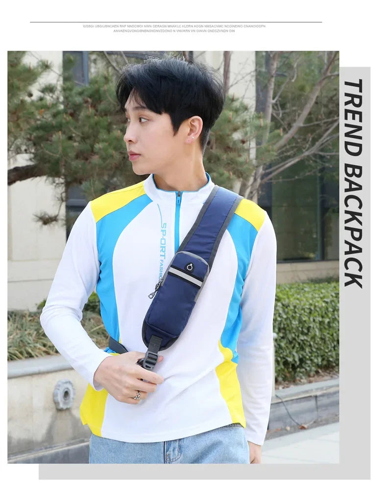 A young man wearing a white long-sleeved shirt with blue and yellow accents, carrying a navy nylon chest sling bag.