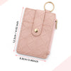 A light pink quilted PU leather card holder wallet with a gold ring and tassel attached.