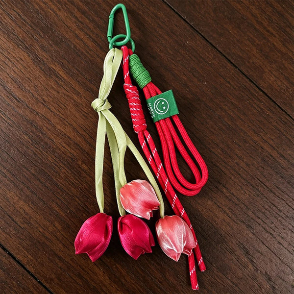 Aesthetic tulip flower bag charm keychain with green and red cord and pink fabric flowers