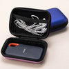 A black portable case with a blue outer shell and an inner compartment for a portable SSD.
