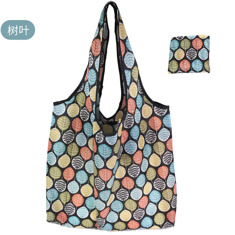 A reusable eco tote shopping bag featuring a pattern of various leaf colors including green, orange, and blue.