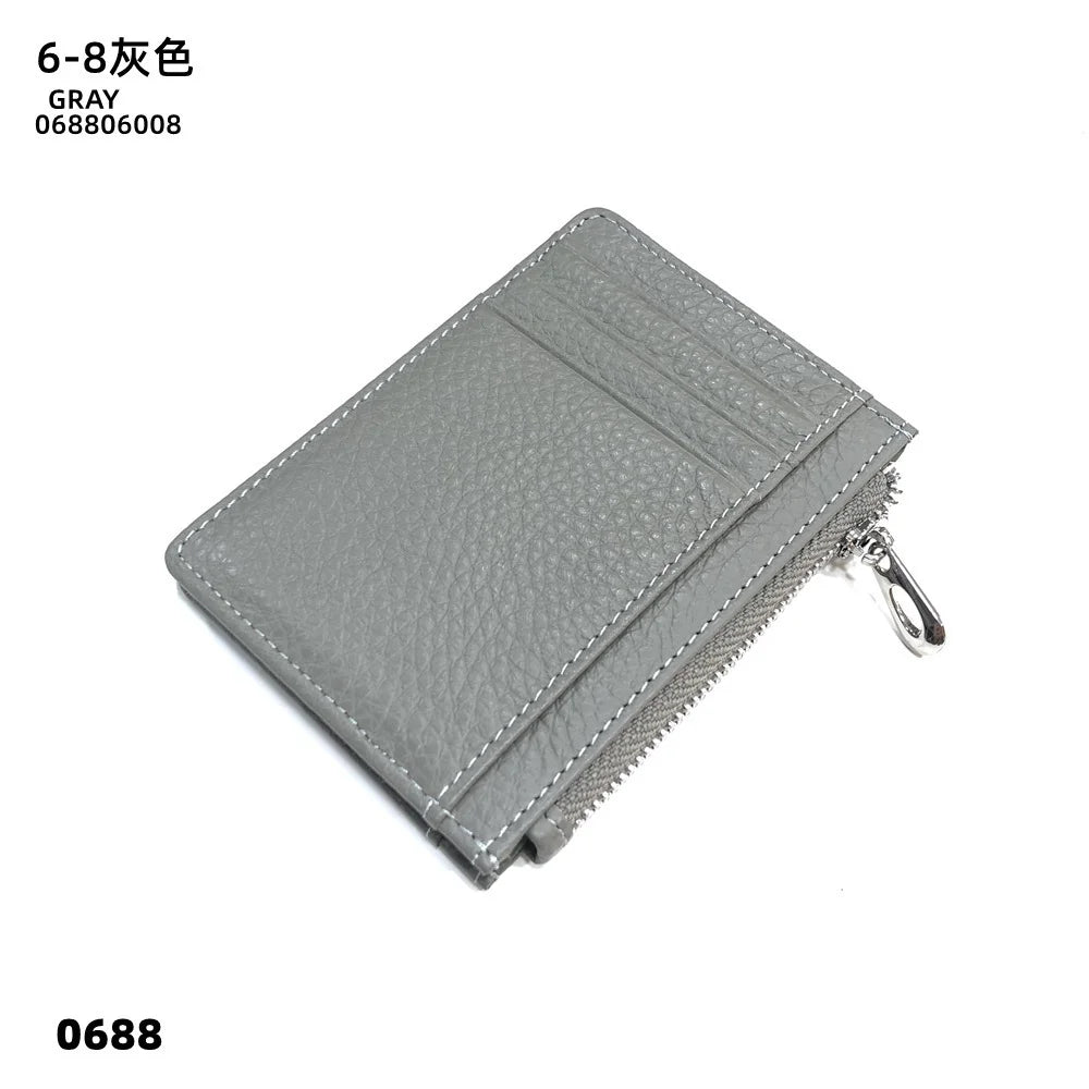 A gray genuine leather zipper card holder with a textured surface and a silver zipper pull.