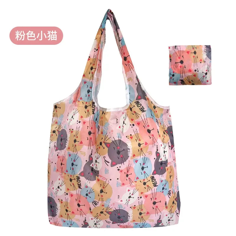 A pink and yellow patterned reusable fashion shopping tote bag with a handle.