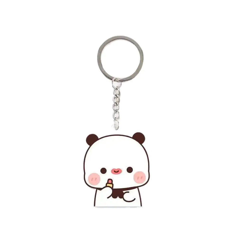 A white cartoon panda charm keychain with a pink nose and smiling expression.