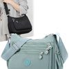 A light blue waterproof nylon crossbody shoulder bag with a gray strap and silver hardware.