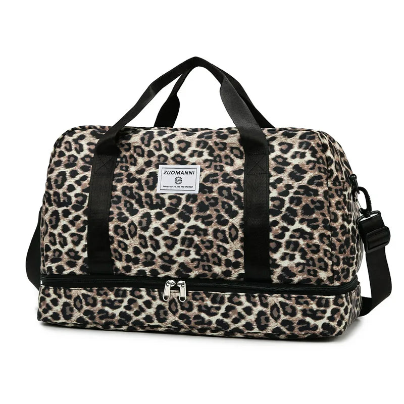 A brown and black leopard print travel duffel bag with a padded shoulder strap.