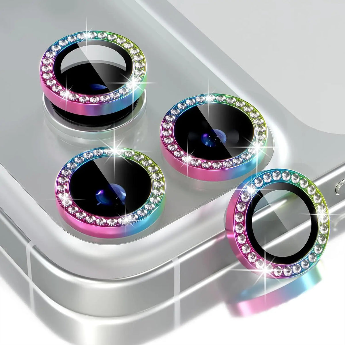 A close-up view of multiple glitter diamond camera lens protectors with metal frames for iPhone.