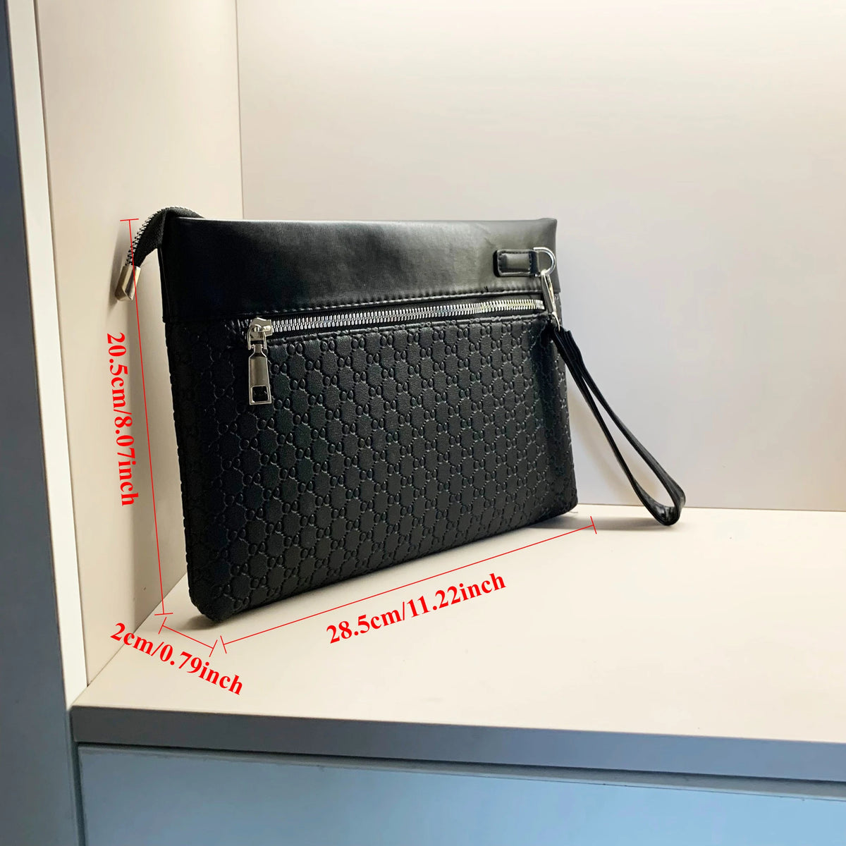 A black PU leather clutch bag with a quilted texture and a zipper closure is displayed on a white surface.
