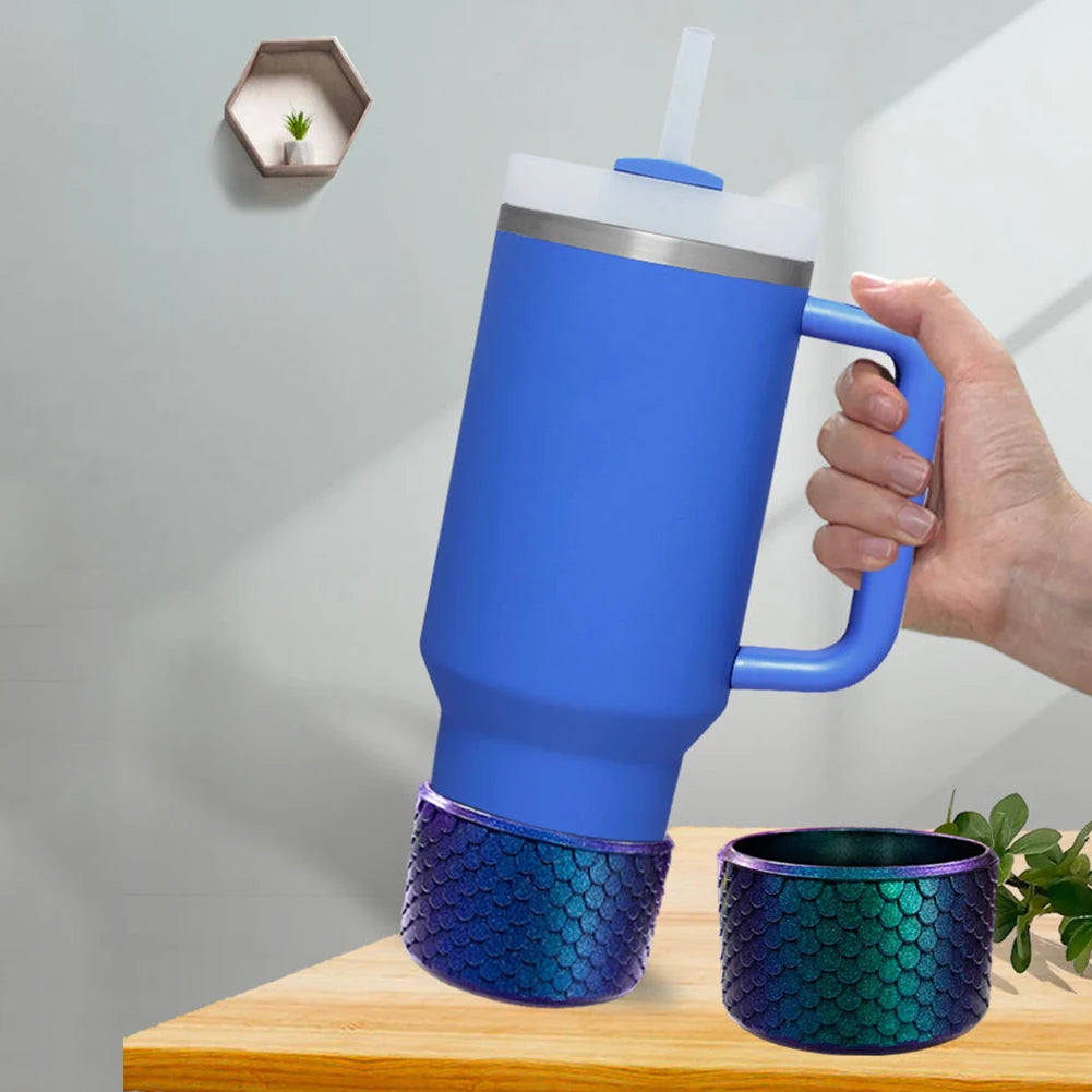 A blue silicone boot sleeve for a water bottle is shown resting on a wooden surface.