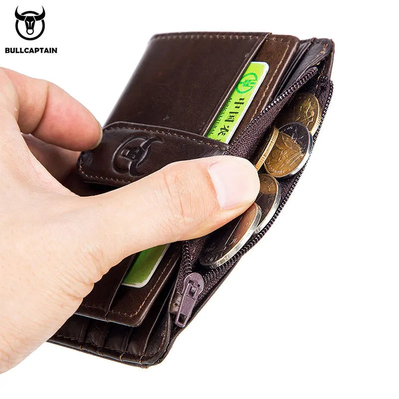 A hand holds a brown genuine leather RFID blocking card holder with multiple slots for cards and cash.