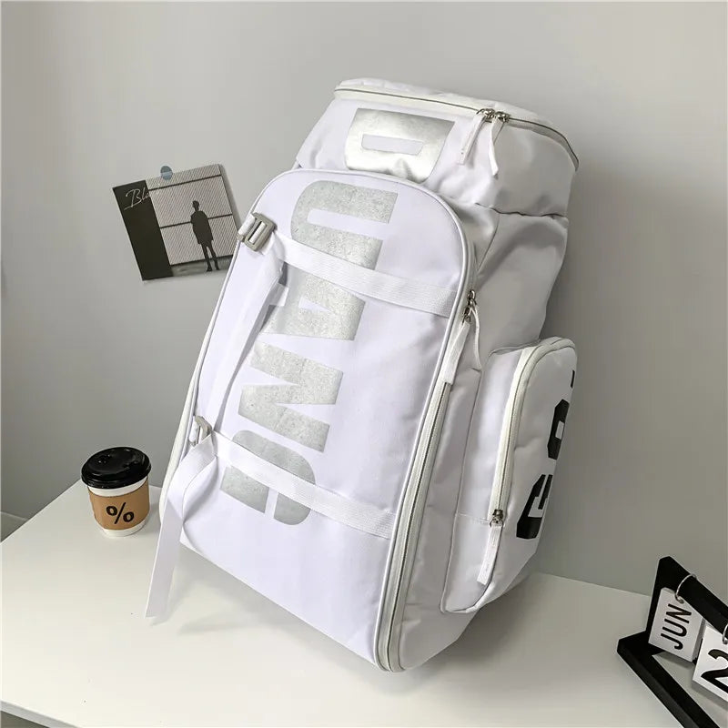 A white waterproof travel gym backpack with gray accents and skateboard straps resting on a white surface.