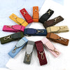 A collection of canvas cotton bag straps in various colors including red, orange, yellow, pink, and olive green, featuring me