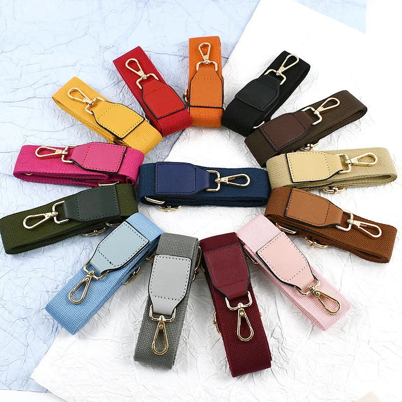 A collection of canvas cotton bag straps in various colors including red, orange, yellow, pink, and olive green, featuring me