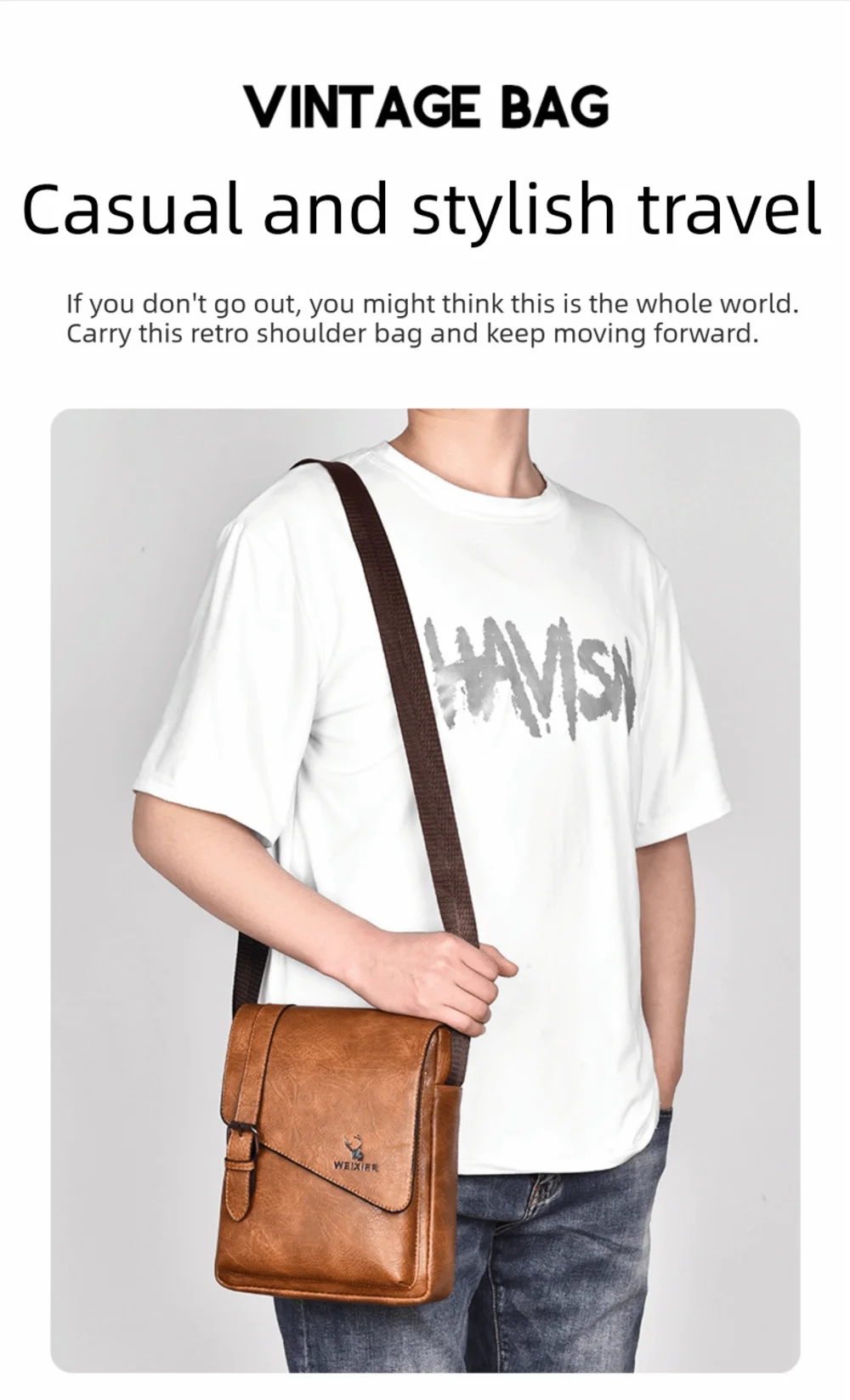 A man wearing a white t-shirt and jeans carrying a brown leather messenger bag across his body.