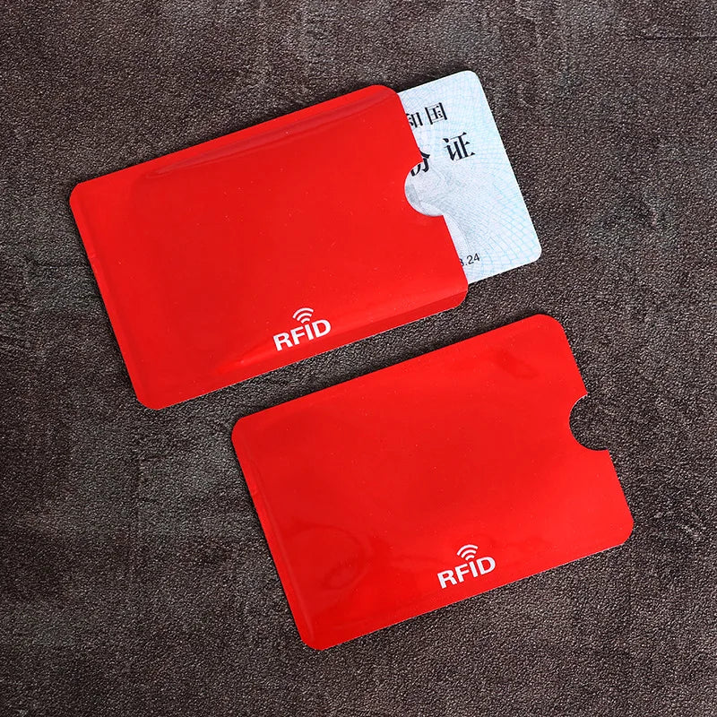 Two red RFID protection cards are shown on a dark surface, with one card displaying an RFID symbol.