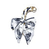 A white fabric bow bag chain strap extension featuring black butterfly print.