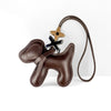 A brown PU leather puppy charm with a bow tie and a leather cord.