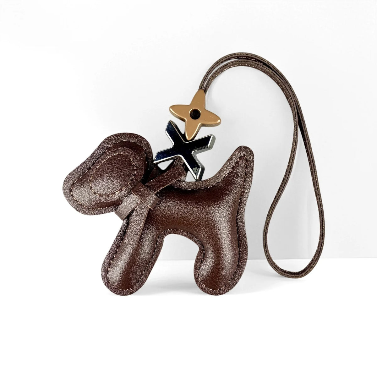 A brown PU leather puppy charm with a bow tie and a leather cord.