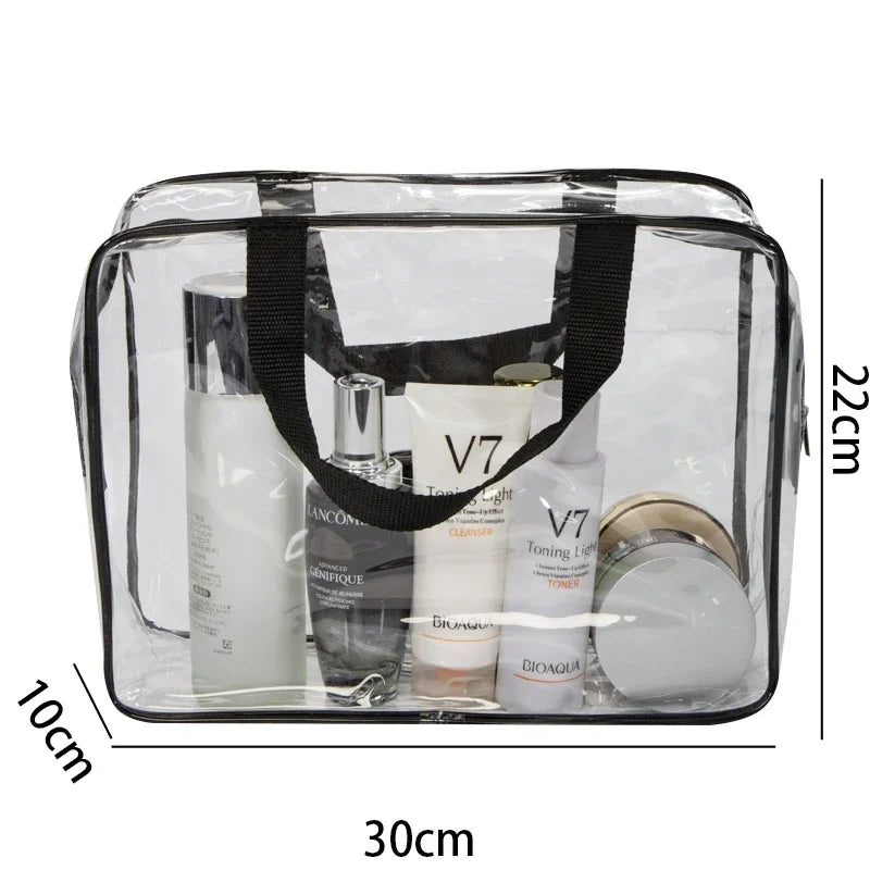 A clear PVC travel toiletry bag set containing three bottles of liquid products and a circular item.