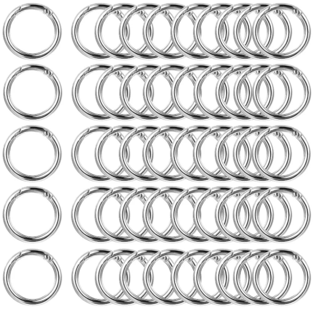 A collection of stainless steel spring clasp keychain rings and carabiner clips.