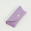 A purple PU leather hard shell sunglasses case lying on a white surface.