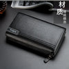 A black leather business handbag clip wallet is shown lying on a dark surface.