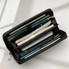 A black multi-card commuter wallet is shown open, displaying various cards and a smartphone.