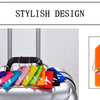 Colorful silicone luggage tags with airplane designs displayed on a silver suitcase.