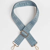 A light blue patterned strap for a crossbody bag featuring a maze design and a gold-toned buckle.