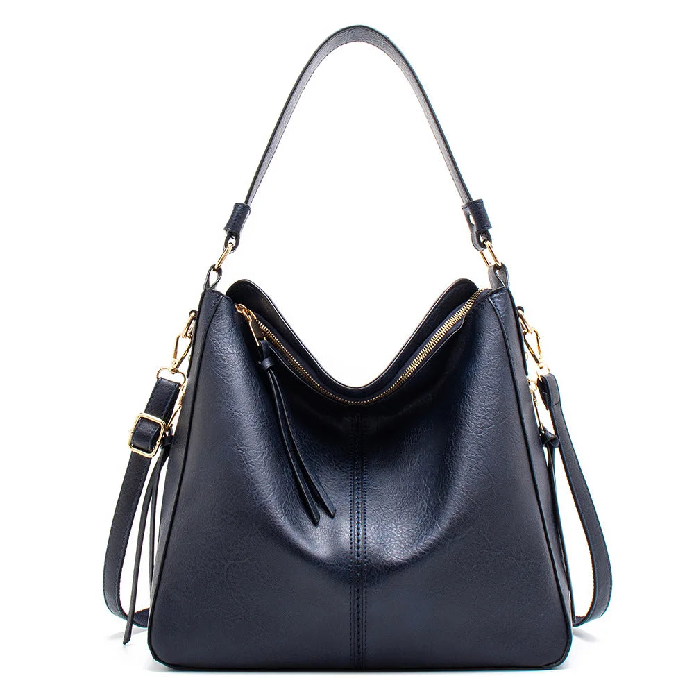 A black vintage faux leather hobo shoulder bag with gold hardware shown from the front.