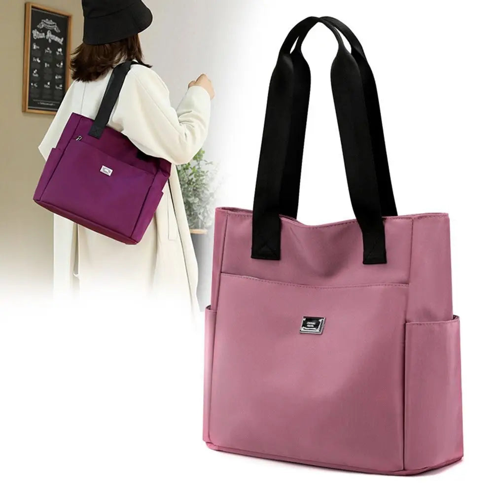 A pink nylon shoulder tote bag is shown being carried by a woman.