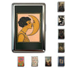 A vintage snap metal card holder featuring a gold-toned illustration of two profiles kissing against a peach background.
