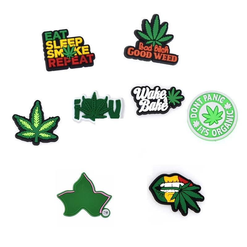 A collection of decorative shoe charms and pins featuring cannabis leaf designs and text like Eat Sleep Smoke Repeat and Bad 