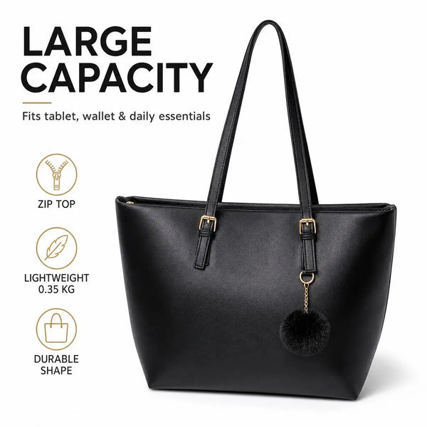 Black PU leather shoulder tote bag with a gold charm and black pom pom detail