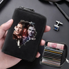 A black compact RFID-blocking card wallet with 11 slots is held in a hand, next to a small silver clip.