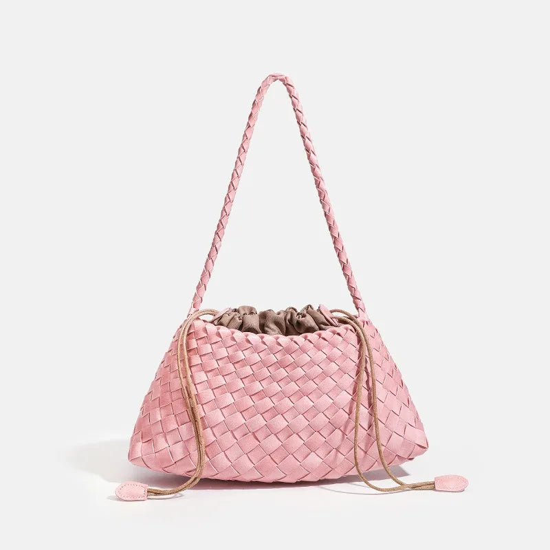 A pink handwoven PU shoulder bag with a woven texture and a long strap is shown against a white background.