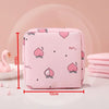 Pink compact sanitary pad storage pouch with a heart pattern and small stars shown on a white surface.