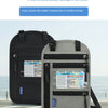 A gray RFID blocking neck wallet is shown next to a black travel bag on a paved surface.