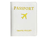 A white PU leather passport holder with gold foil printing of an airplane symbol and the words PASSPORT and TRAVEL WALLET.