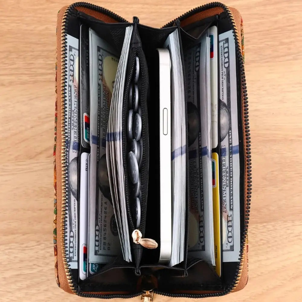 A brown leather wallet is open, displaying multiple stacks of cash and various cards inside.