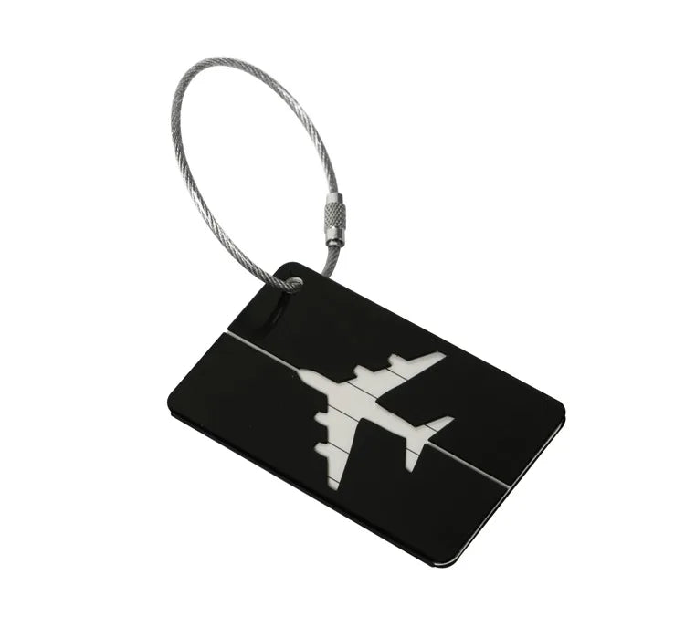 A black durable aluminum luggage tag with a silver cord attached.
