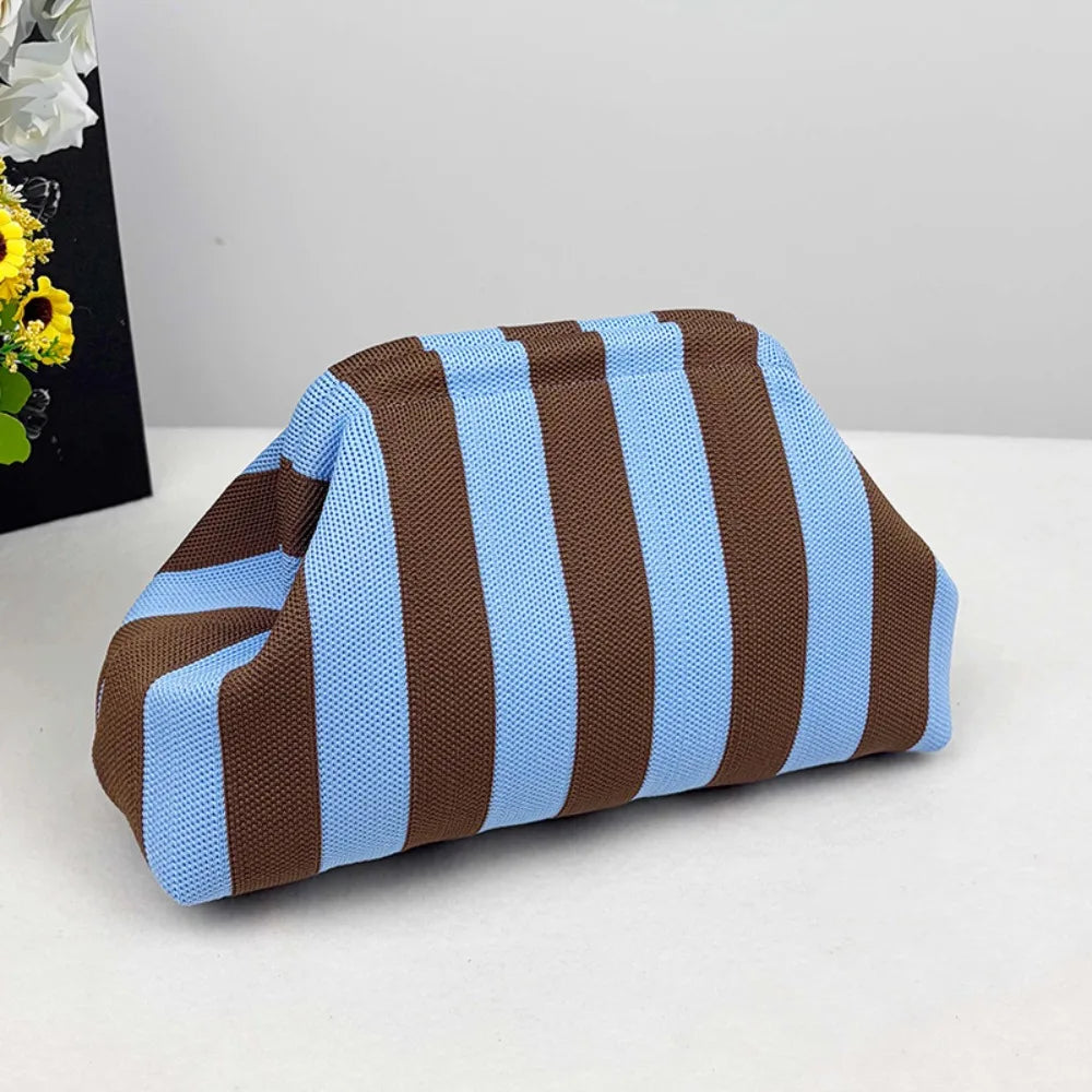 A striped knit makeup bag featuring brown and light blue horizontal stripes.